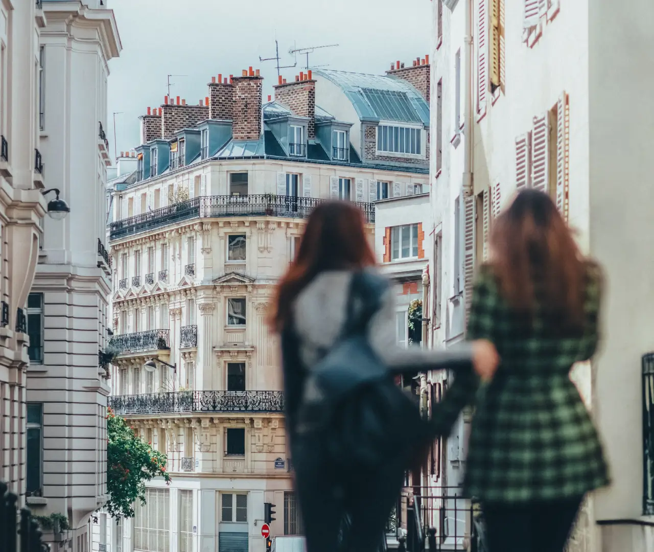 Two people walking in Parisian street scene.