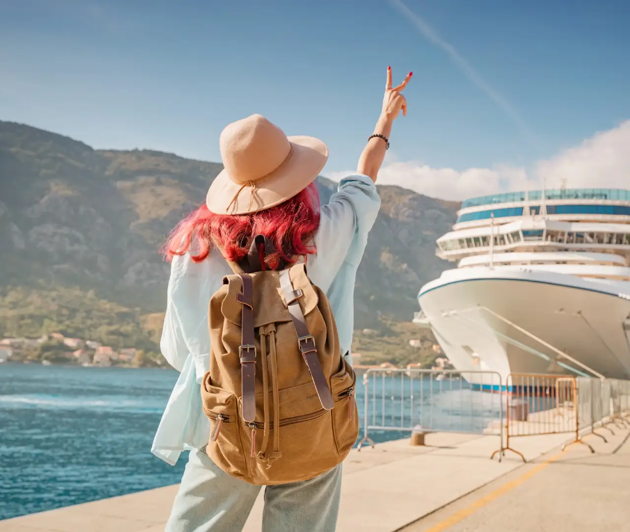 Traveler by cruise ship, peace sign gesture.